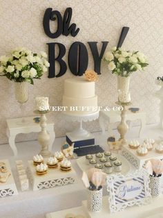 a baby shower party with cake and cupcakes