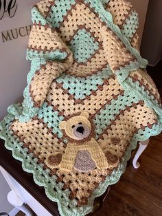 a crocheted blanket with a teddy bear on it