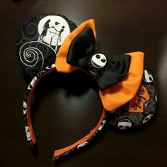 a black and orange mickey mouse headband with a skeleton on it's side