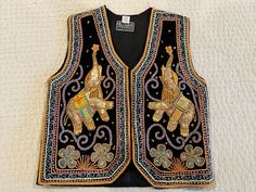 "Very interesting, unusual vest from about 4 years ago that was made in Thailand or Myanmar of the design of elephants made with sequins.  Very unusual and fun to wear as these may be hard to find today. Tag says large, one size but I think it would fit a Medium better, even a small.  You need to measure yourself and see what matches the measures I give.     Measures 20\" across under arms and 21.5\" from mid neck to bottom.  Clean and in very good condition.  This was made by Hilltribes Clothin Elephant Embroidery, Very Interesting, Vest Outfits, Myanmar, Womens Vest, Bend, Desi, Thailand, Elephant