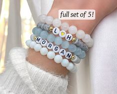 A set of 5 custom handmade bracelets with personalized names! Makes a great gift for your Wife, Bride, best friend, Mom, or even yourself! * Please scroll through the photos for helpful info on Size, Material, and Color Options. * These bracelets are FULLY CUSTOM, which means they are FINAL SALE. * Please be sure to double check all spelling and color selections prior to checkout. * All orders come sweetly wrapped and ready for gift-giving. Find more of my bracelets here! https://www.etsy.com/sh Customizable Casual Jewelry For Personalized Gifts, Casual Customizable Jewelry For Personalized Gift, Casual Customizable Personalized Gift Jewelry, Casual Personalized Beaded Bracelets For Gift, Handmade White Friendship Bracelets For Personalized Gift, Casual Bracelets With Custom Text For Gifts, Casual Bracelets With Custom Text, Casual Customizable Beaded Bracelets As Personalized Gift, Casual Customizable Beaded Bracelets For Personalized Gifts