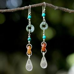 Take an adventurous approach to life with these long dangle earrings from Somluck Komolmith in Thailand. Featuring teardrop-shaped charms of hill tribe silver that are stamped with assorted traditional motifs, the earrings are crafted from jade, dyed quartz and turquoise-hued calcite. Sterling silver, jade, dyed quartz, dyed calcite Hook earrings Combination finish Handmade in & fairly-traded from Thailand Due to the handmade nature of this product, exact color may vary. Jewelry Pics, Earring Shapes, Beaded Earrings Diy, Hill Tribe Silver, Earring Ideas, Beads Earrings, Earring Tutorial, Jewelry Wire, Homemade Jewelry