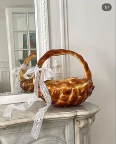 a basket sitting on top of a white table next to a mirror and a wall