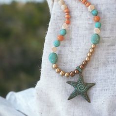 Boho Style Necklace With Bleached Wood Beads, Turqouise Stones, Orange Wood Beads And Orange Stone Beads. Accents Of Copper And Gold . Necklace Length 28" With Pendant Adding An Additional 3" Bohemian Star-shaped Beaded Necklaces, Bohemian Star-shaped Beaded Necklace, Multicolor Beaded Starfish Jewelry, Starfish Beaded Necklace For Summer, Bohemian Star Beaded Necklaces For Jewelry Making, Bohemian Starfish Beaded Necklaces, Bohemian Star Shaped Beaded Necklaces For Gifts, Multicolor Starfish Shaped Beaded Jewelry, Bohemian Beaded Starfish Necklace