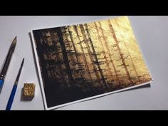 a painting with gold foil and some paintbrushes