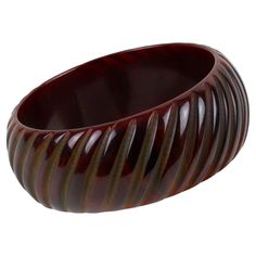 This is a fabulous red sangria Bakelite bracelet bangle. It features a chunky domed shape with geometric and deeply carved designs. The color is an intense dark red marble tone with a chocolate brown overtone. Measurements: Inside across is 2.57 in diameter (6.5 cm) - outside across is 3.19 in diameter (8 cm) - width is 1.13 in (2.8 cm) - The inner circumference of the bracelet is 8.04 in (20.41 cm). Feel free to double-check the measurements and ask any questions you have before making your purchase. This item is a final sale. We will not accept returns for an unfit size. Layered Bangles, Modern Bangle, Lucite Bracelets, Bakelite Bracelets, Pave Bracelet, Red Sangria, Red Marble, Bronze Bracelets, Resin Bracelet