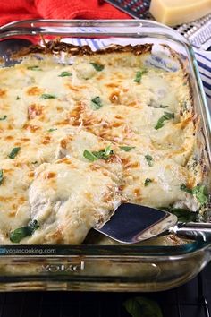 a casserole dish with cheese and spinach