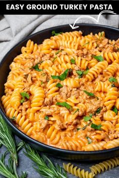 an easy ground turkey pasta dish in a black bowl with herbs on the side and text overlay that says easy ground turkey pasta