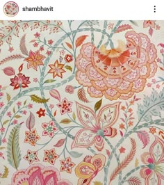 the fabric is very colorful and has many flowers on it, including pinks and oranges