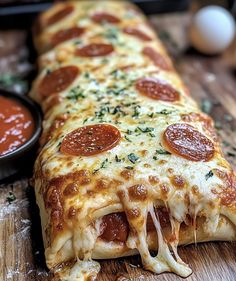 a pepperoni pizza on a cutting board next to some condiments and sauce