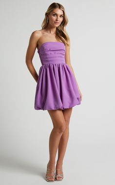 Elevate your party night game with our Shaima Strapless Mini Dress in Orchid. This dress is the perfect choice for those who want to show off their shoulders and embrace their feminine side. Our fit & flare style ensures a flattering silhouette that will have you feeling confident all night long. The vibrant purple hue adds a pop of color to any occasion, while the mini length keeps things flirty and fun.Whether it's a summer soirée or winter wonderland, this dress is transeasonal and versat Prom Mini Dress With Ruched Bodice, Spring Strapless Mini Dress With Ruched Bodice, Summer Party Off Shoulder Dress With Ruched Bodice, Summer Party Off-shoulder Dress With Ruched Bodice, Summer Off-shoulder Dress With Ruched Bodice For Party, Strapless Spring Mini Dress With Ruched Bodice, Strapless Ruched Mini Dress For Prom, Strapless Mini Dress With Ruched Bodice For Spring, Chic Off Shoulder Dress With Ruched Bodice For Party