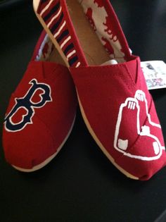 a pair of boston red sox slippers sitting on top of a black countertop