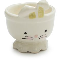 a white ceramic bowl with a cat design on the front and bottom, sitting in front of a white background