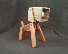 a wooden toy with a light on it's head and legs that are connected to wires