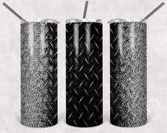 three black and white cans with straws in them