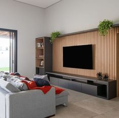 a large flat screen tv mounted to the side of a wall in a living room