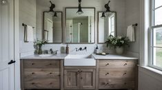 a bathroom with two sinks and three mirrors