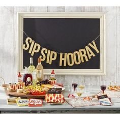 there is a sign that says sipp hooray on it and some wine glasses