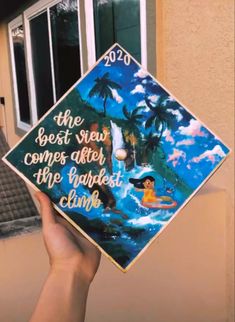 someone is holding up a graduation cap that says the best view comes after the highest climb