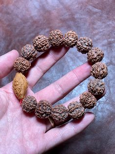 Unisex bracelet made with 14 six face/mukhi Nepal Rudraksha raw beads (not cleaned)  Shape: Round Main Bead: One of a kind red agate with cylindrical shape *Fit mid wrist well. If you have small wrist it might be little loose but will look very cool. All beads are blessed by a monk in Nepal. Spiritual Gemstone Beads Bracelet For Festivals, Spiritual Round Bracelets For Festivals, Adjustable Carved Bracelets With Round Beads, Spiritual Red Bracelets For Rituals, Red Spiritual Bracelets For Rituals, Traditional Bracelets With Natural Stones For Meditation, Spiritual Carved Jewelry For Puja, Hand Wrapped Spiritual Bead Bracelet, Traditional Round Beads Healing Bracelet