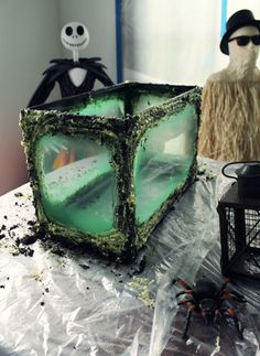 there is a cake made to look like a cube with green frosting on it