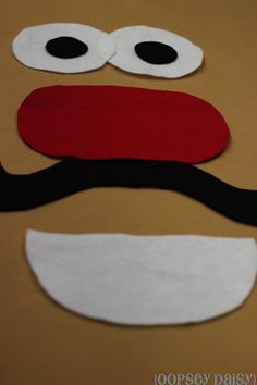 a close up of a paper cut out of a face with googly eyes and a mustache