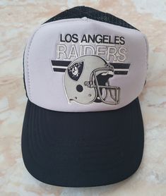 Pre-owned Original Rare Vintage NFL Los Angeles Raiders Trucker Hat Snapback Eurocap.Made in Taiwan 80's Very good condition,for those years, there is no damage or defects,but on a plastic strap,one rivet broke off,but not lost.For reference look at the photos.  Colors are in good condition,hat looks 9.0/10. Size: One Size fits mos Postage: Delivery times may be more than 14 days. If you have any questions, you can ask me them, I am always ready to answer. Thank you in advance! Raiders Snapback Hats, Los Angeles Raiders, Hats Snapback, Mesh Cap, Rivets, Trucker Cap, Taiwan, Caps Hats, Trucker Hat