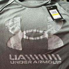 Nwt Under Armour Men’s Grey Wick-Away Type Material Tshirt Grey Logo On Front Of Shirt Under Armour Crew Neck T-shirt With Logo, Under Armour Crew Neck Top With Letter Print, Under Armour Sporty Tops With Letter Print, Sporty Under Armour Tops With Letter Print, Under Armour Gray Crew Neck Top, Under Armour Moisture-wicking Tops For Streetwear, Compression Shirt, Under Armour Shirts, Under Armour Men