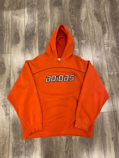 Description: Adidas distressed spellout hoodie Flaws: Distressing on sleeves/hood, holes on front, please see pictures Size: L Length: 28" Pit to Pit: 24.5" Sleeve: 23.5" Brand: Adidas Era: 2010s Color: Orange Store Item #IN320 Vintage Hoodie With Double-lined Hood For Sports, Adidas Hoodie With Ribbed Cuffs For Sports Season, Crew Hoodie For Streetwear During Sports Season, Vintage Hoodie For Streetwear In Fall, Adidas Hoodie With Logo For Streetwear, Adidas Cotton Hoodie For Sports, Vintage Hoodie With Drawstring Hood For Streetwear, Vintage Hoodie For Fall Streetwear, Vintage Hooded Sweatshirt For Streetwear