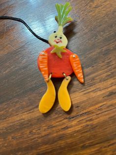 a wooden table topped with an ornament shaped like a carrot