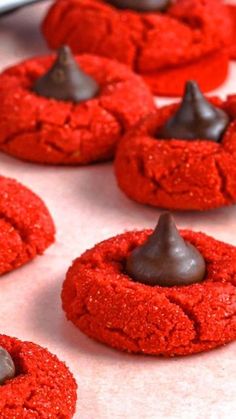 some red cookies with chocolate on top of them