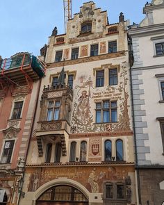 an old building with many windows on the front and side walls that have been painted in different colors