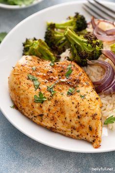 a white plate topped with chicken, rice and broccoli