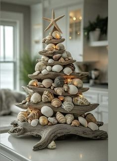 a christmas tree made out of seashells and starfish on a kitchen counter