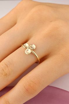 Our 14k Solid Gold Three Leaf Clover Ring is a stunning piece that captures the essence of nature's beauty. Crafted from solid gold, this ring exudes a sense of elegance and sophistication. The three leaf clover design adds a touch of whimsy and symbolism, making it a meaningful accessory to wear. The golden hue of the ring complements all skin tones, adding a warm glow to your hand. The intricate details of the leaves bring the design to life, showcasing the craftsmanship and attention to detail that went into creating this exquisite piece of jewelry. Perfect for both formal occasions and everyday wear, this ring is versatile and timeless. It can be stacked with other rings or worn on its own as a statement piece. Our 14k Solid Gold Three Leaf Clover Ring is a truly special piece that wil 14k Gold Polished Toe Ring, Fine Jewelry 14k Gold Flower Ring For Anniversary, 14k Gold Flower Ring For Anniversary, 14k Gold Round Flower Ring Fine Jewelry, 14k Yellow Gold Toe Ring With Flower Design, 14k Yellow Gold Flower Toe Ring, Yellow Gold Round Flower Ring Gift, Yellow Gold 14k Flower Toe Ring, Sterling Silver Flower Ring In Yellow Gold