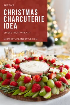 a platter filled with fruit and dip surrounded by christmas decorations