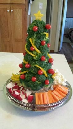 a christmas tree made out of broccoli, carrots and radishes