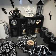 a kitchen counter topped with lots of halloween decorations and decorating items on top of it