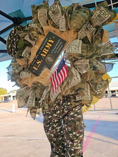 a wreath made out of dollar bills with an american flag