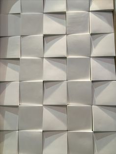 white tiles are arranged in the shape of squares