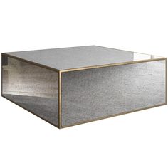 a silver and gold box sitting on top of a table