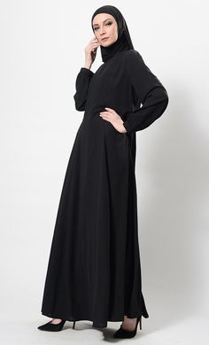 Featuring a classic comfortable flared full length abaya dress in nida fabric with princess seams on the sides and balloon shaped sleeves with elasticated edges. It is a casual everyday wear informal abaya dress. FIT : Relaxed fit.COMPOSITION : Nida.CARE : Dry clean only. Long Sleeve Modest Abaya With Modesty Panel, Modest Long Sleeve Abaya With Modesty Panel, Solid Long Sleeve Maxi Dress For Eid, Modest Long Sleeve Thobe With Modesty Panel, Modest Long Sleeve Solid Khimar, Modest Floor-length Abaya, Solid Long Sleeve Dresses For Eid, Modest Solid Color Floor-length Abaya, Eid Abaya With Modesty Panel In Solid Color