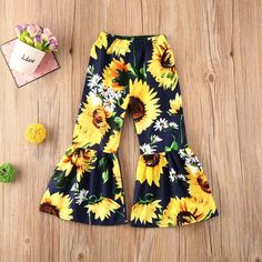 Sunflower Flare Pants. Super trendy and cute for your little babe. Playful Floral Print Bottoms For Spring, Cute Wide Leg Spring Bottoms, Summer Playful Floral Print Bottoms, Playful Floral Print Summer Bottoms, Playful Floral Print Spring Bottoms, Cute Summer Pants With Elastic Waistband, Cute Floral Print Cotton Bottoms, Cute Cotton Bloomers With Floral Print, Cute Stretch Pants For Spring