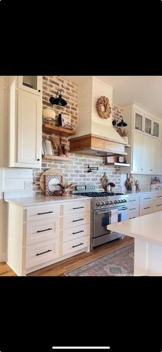 a kitchen with white cabinets and an oven