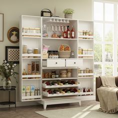 a living room filled with lots of furniture and shelves full of food on top of them