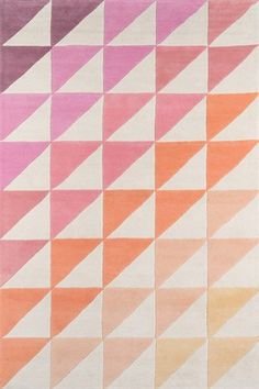 a rug with an abstract design in pink, orange and yellow colors on the floor