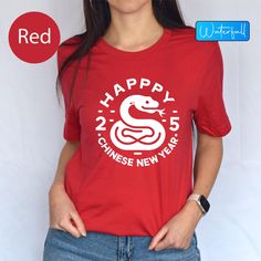 Happy New Year Chinese 2025 Gift Tshirts, Snake Shirts For New Year 2025, Year Of The Chinese Snake 2025 Tee, Lunar New Year 2025 Gift Shirt Celebrate the Chinese New Year 2025 in Style with this ""Happy Chinese New Year"" T-Shirt! Get ready to welcome the Year of the Snake with this vibrant and festive ""Happy New Year"" t-shirt, perfect for celebrating the Lunar New Year. This ""Chinese 2025 Gift Shirt"" is designed to bring good luck and joy, featuring a unique snake design that captures the New Year Red T-shirt With Graphic Print, Red Graphic Print T-shirt For New Year, Red Short Sleeve T-shirt For New Year, New Year Red Letter Print T-shirt, Red Letter Print T-shirt For New Year, New Year Graphic Print Short Sleeve T-shirt, Red Letter Print Top For New Year, Casual Short Sleeve Tops For New Year, 2025 Year