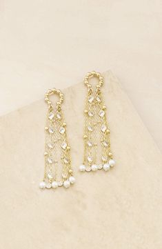 These beaded frontal hoop earrings are strung with cubic zirconia and imitation pearls that move with you. 3 1/4" drop 18k-gold plate/cubic zirconia/acrylic imitation pearl Imported Elegant Chandbali Beaded Earrings With Dangling Beads, Elegant Festive Beaded Chandelier Earrings, Gold Jeweled Pearl Earrings, Elegant Jeweled Gold Beaded Earrings, Elegant Gold Jeweled Beaded Earrings, Festive Gold Beaded Earrings With Pearl Drop, Gold Hoop Earrings With Dangling Beads For Wedding, Festive Gold Beaded Pearl Earrings, Elegant Beaded Earrings For Reception