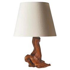 a wooden table lamp with a white shade on the top and bottom part of it