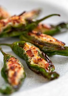 some green peppers are on a white plate